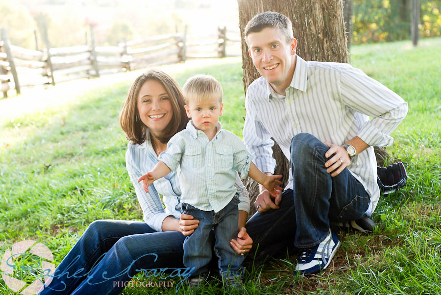 Family sitting under a tree in Derwood, MD which is near Rockville