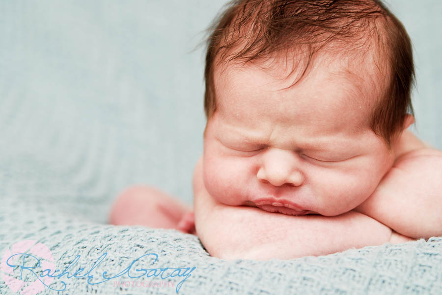 Newborn portrait session with baby on blanket